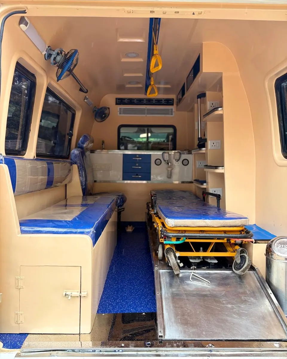 Inside the Sri Loukya ambulance: patient stretcher, attendant seat, wall-mounted oxygen fittings and storage cabinets